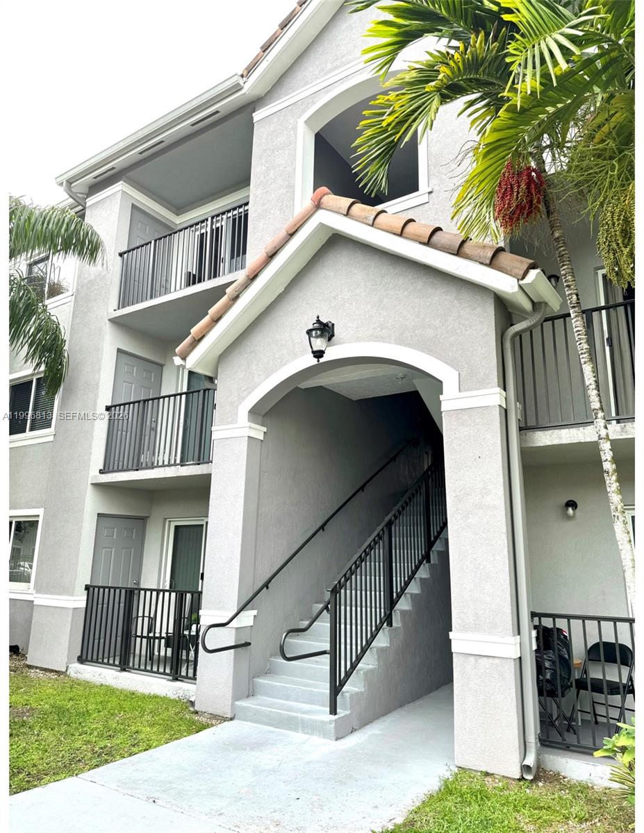15480 Southwest 284th Street, Unit 2307 Homestead, FL 33033 - Photo 2 of 19 a view of a house with a yard plants and wooden fence