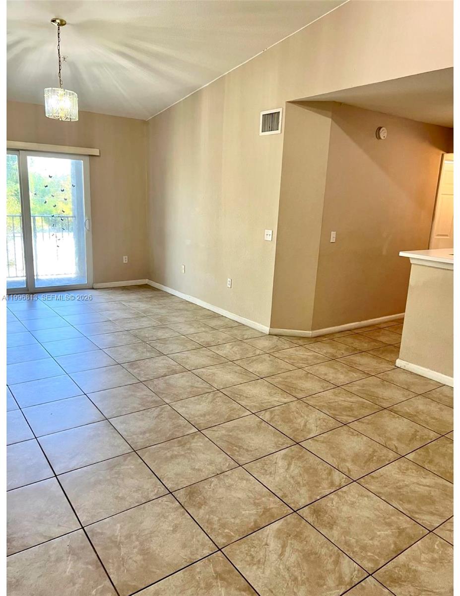 15480 Southwest 284th Street, Unit 2307 Homestead, FL 33033 - Photo 4 of 19 a view of an empty room with a window