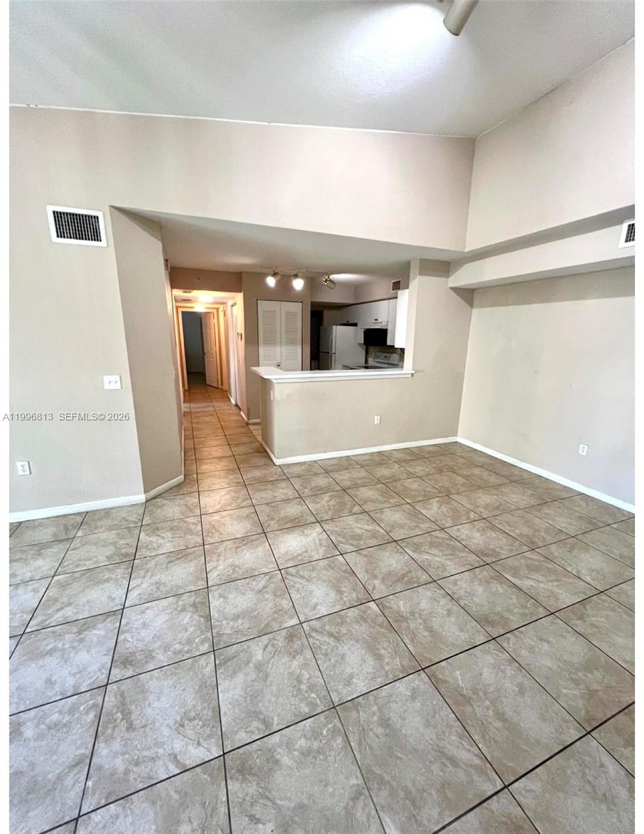 15480 Southwest 284th Street, Unit 2307 Homestead, FL 33033 - Photo 6 of 19 a view of livingroom with an empty space and window