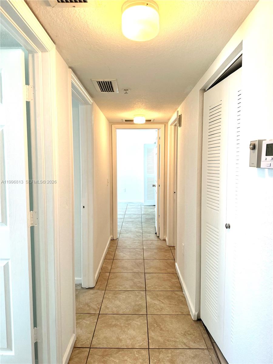 15480 Southwest 284th Street, Unit 2307 Homestead, FL 33033 - Photo 9 of 19 a view of a hallway with windows