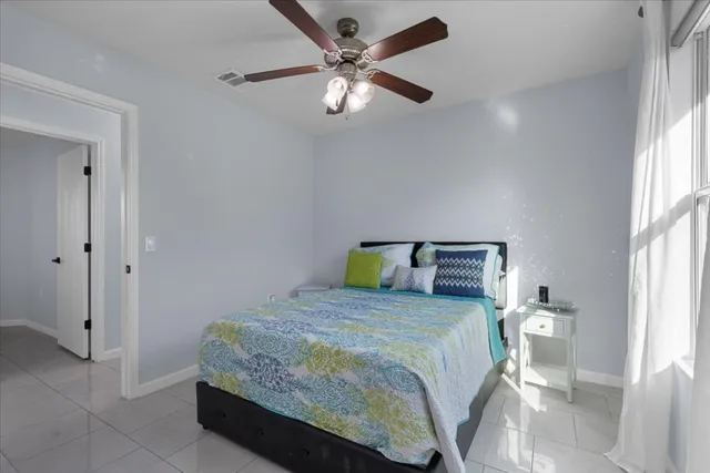 a bedroom with a bed and a large window