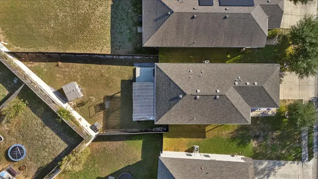 an aerial view of a house with large trees