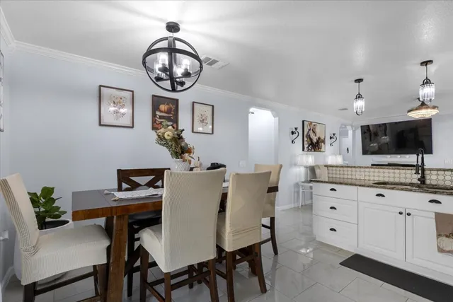 a view of a dining room with furniture and a mirror