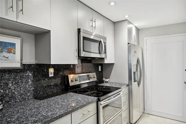 a kitchen with stainless steel appliances granite countertop a stove and a sink