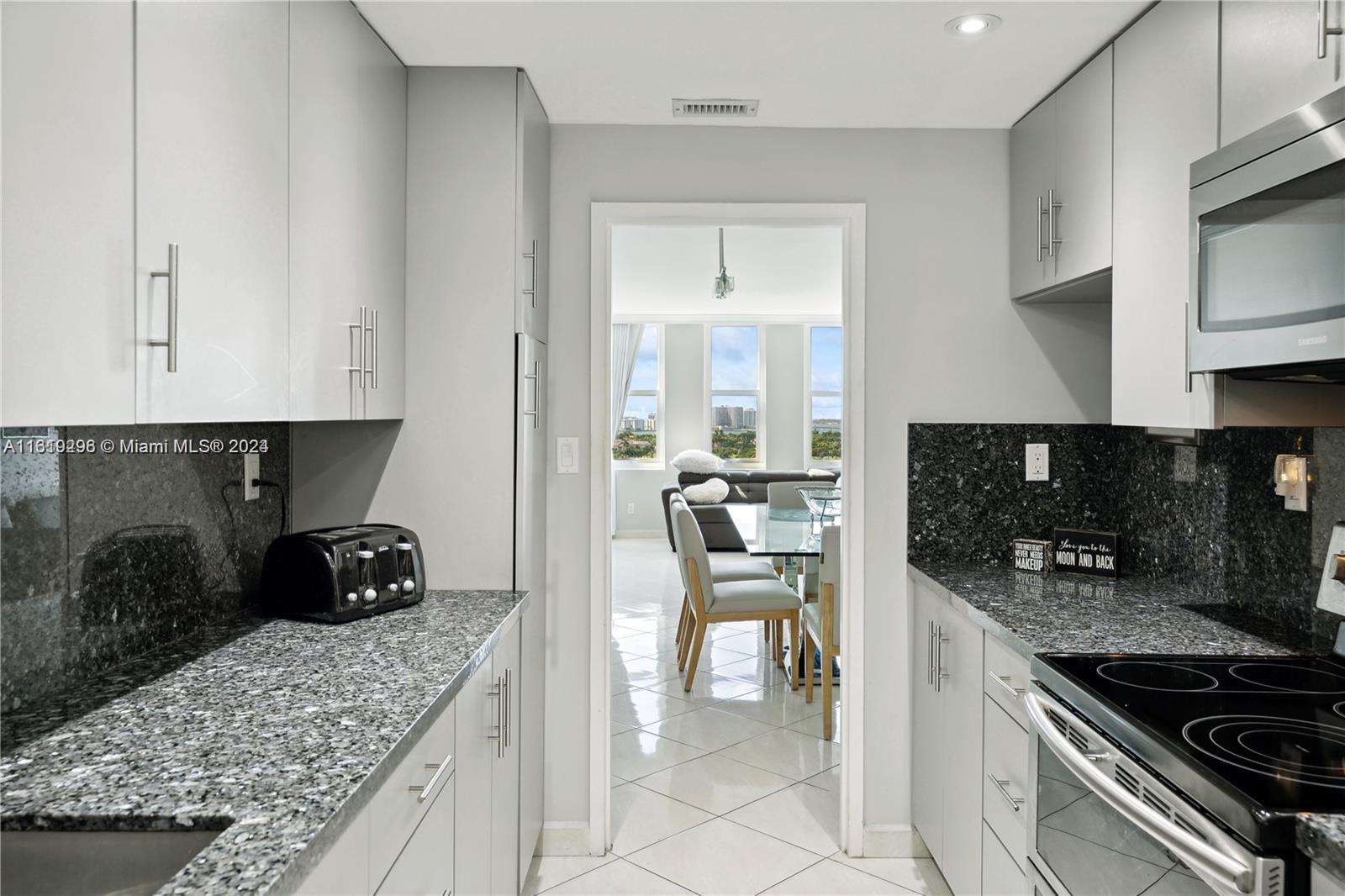 5401 Collins Avenue, Unit 1123 Miami Beach, FL 33140 - Photo 26 of 38 a kitchen with stainless steel appliances granite countertop a stove and a sink