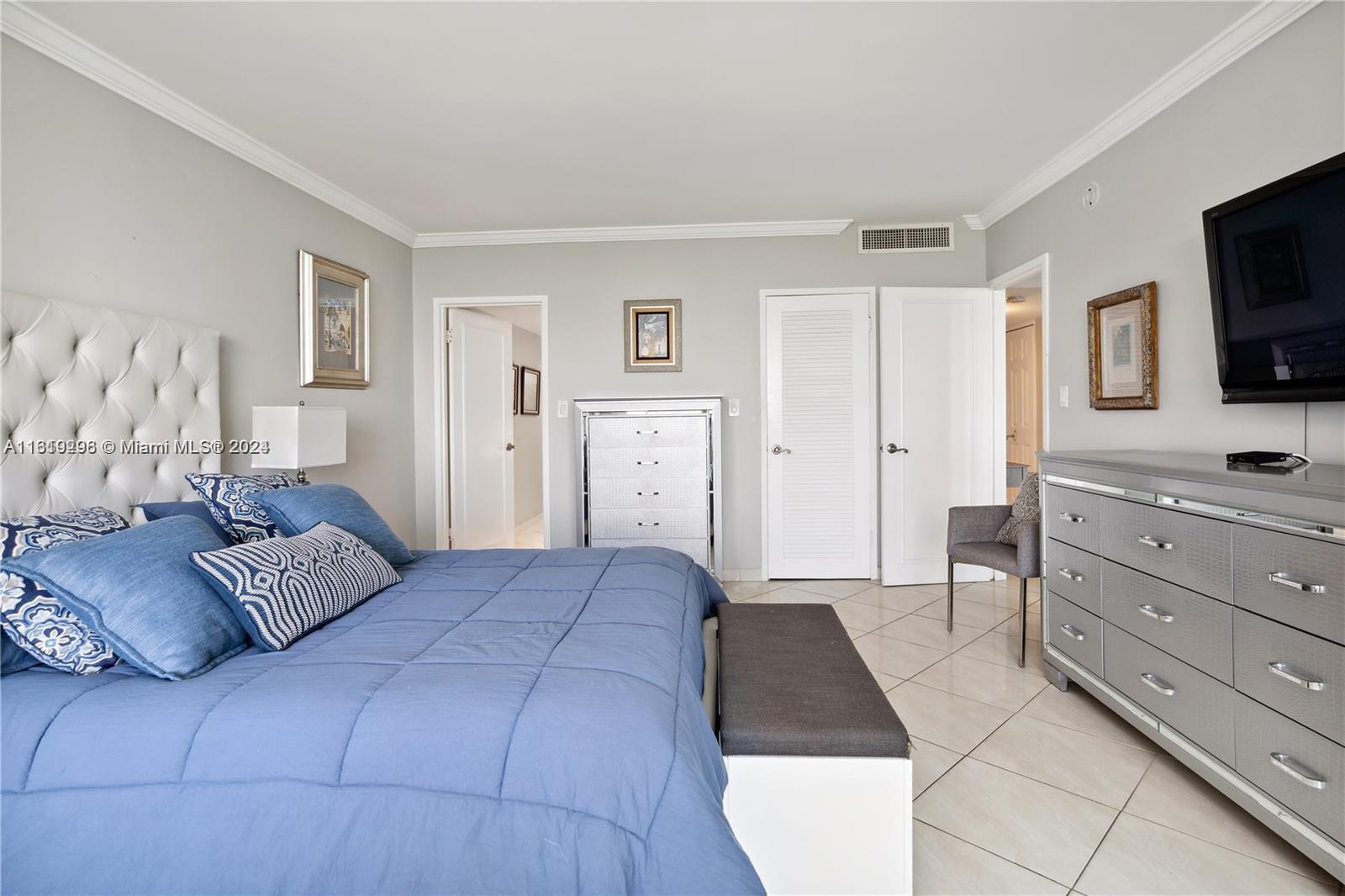 5401 Collins Avenue, Unit 1123 Miami Beach, FL 33140 - Photo 28 of 38 a bedroom with a bed and a flat screen television