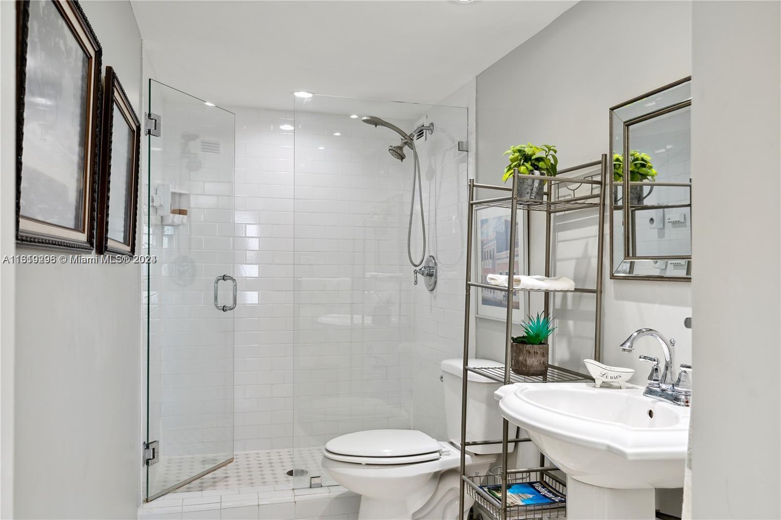 5401 Collins Avenue, Unit 1123 Miami Beach, FL 33140 - Photo 30 of 38 a bathroom with a sink toilet and shower