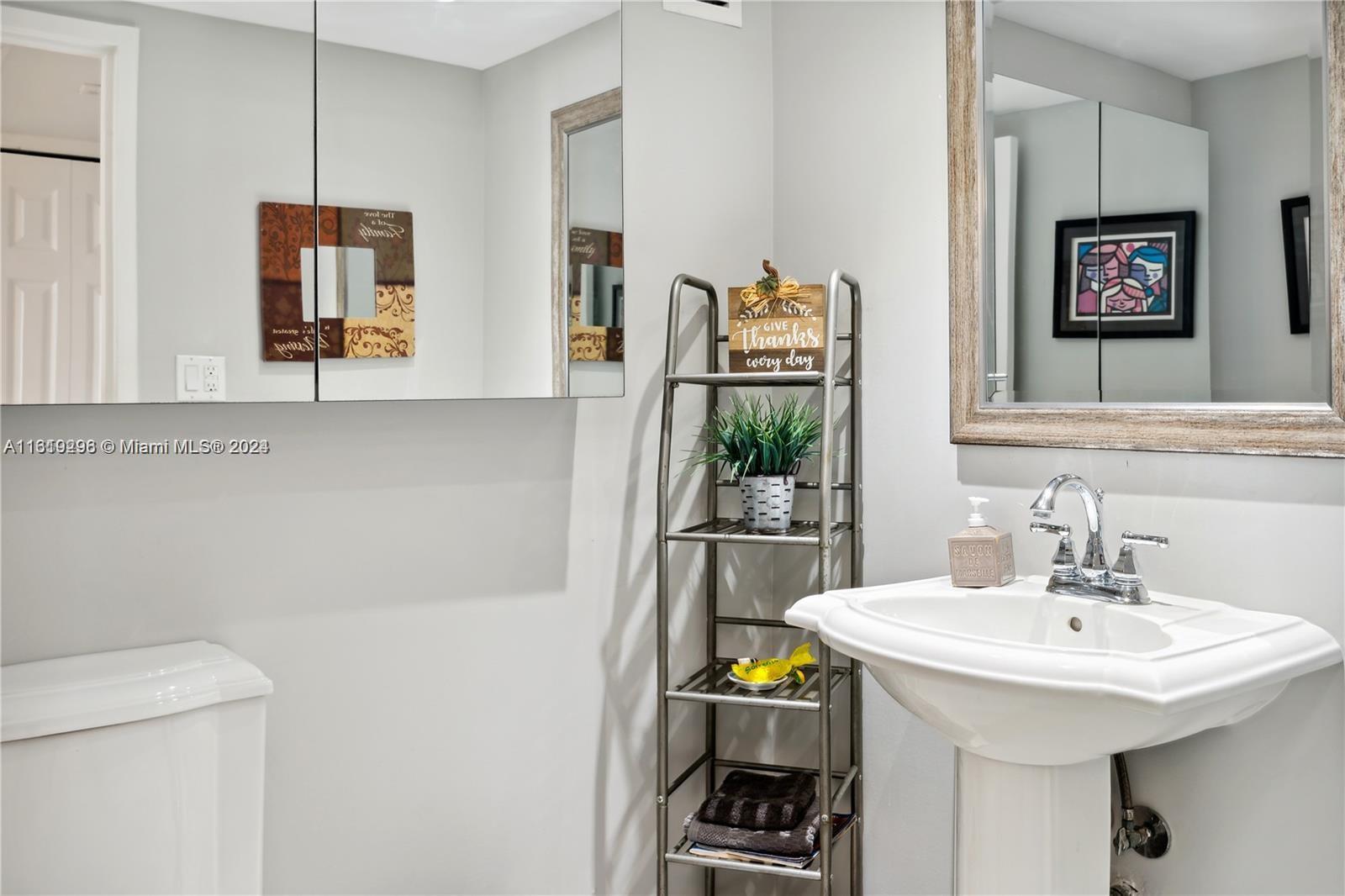 5401 Collins Avenue, Unit 1123 Miami Beach, FL 33140 - Photo 31 of 38 a bathroom with a sink and a mirror