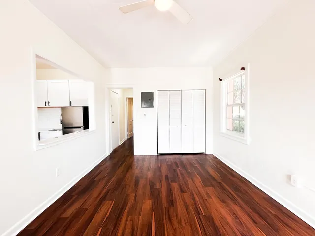 a view of a room with wooden floor