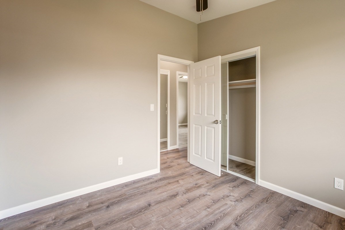 4722 Mailihuna Road Kapaa, HI 96746 - Photo 12 of 22 an empty room with wooden floor and windows