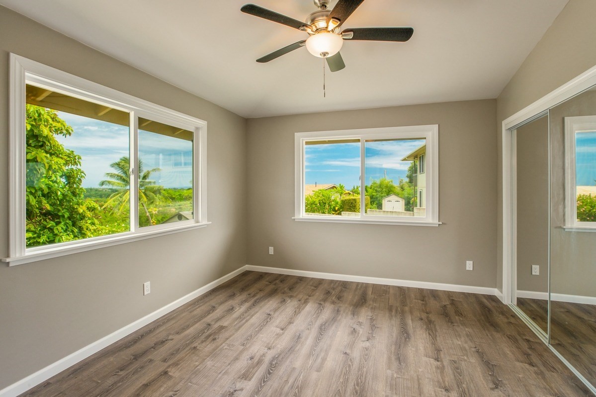 4722 Mailihuna Road Kapaa, HI 96746 - Photo 14 of 22 a view of an empty room with wooden floor and a window