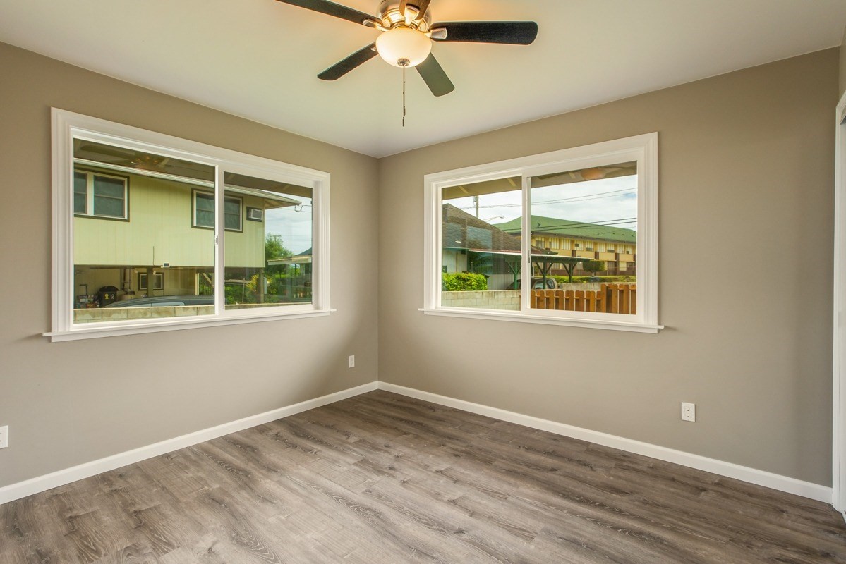 4722 Mailihuna Road Kapaa, HI 96746 - Photo 18 of 22 a view of an empty room with a window and wooden floor