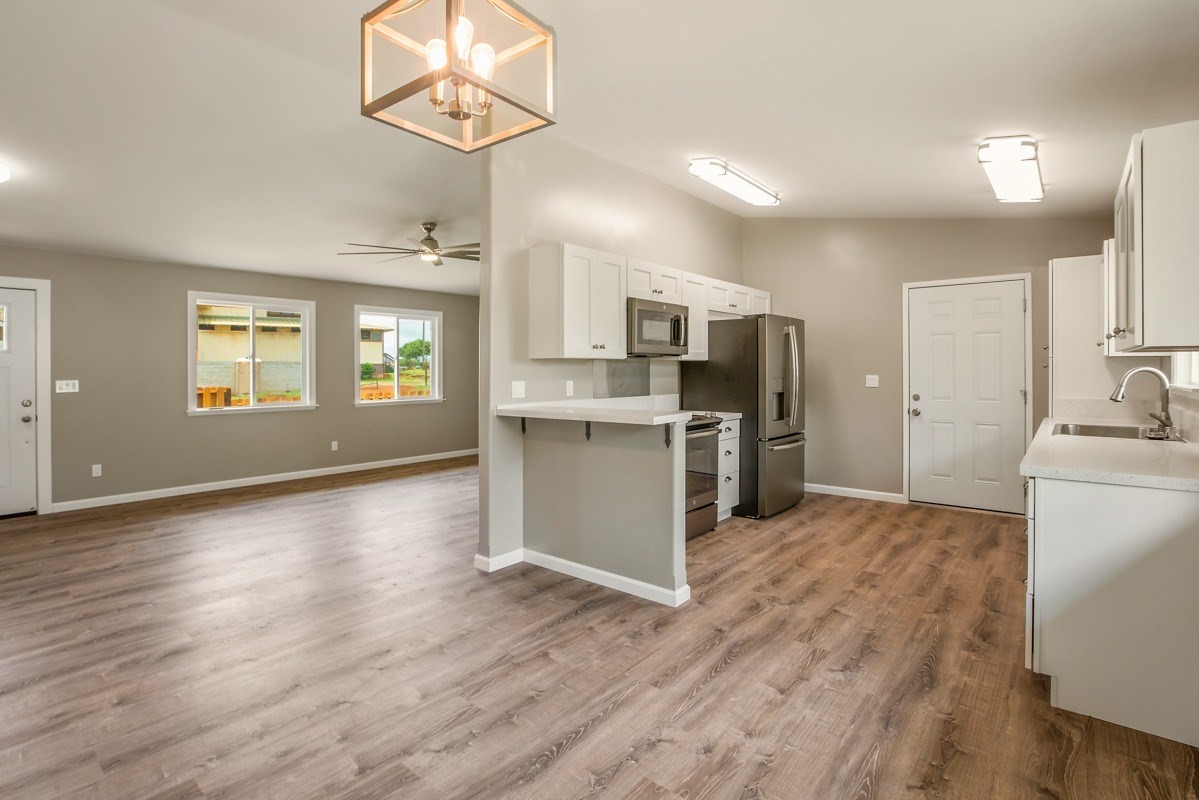 4722 Mailihuna Road Kapaa, HI 96746 - Photo 4 of 22 a view of a kitchen with a sink a refrigerator and a window