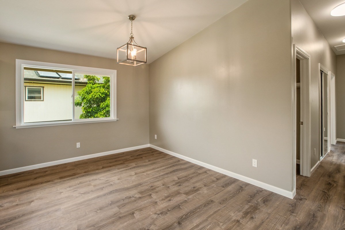 4722 Mailihuna Road Kapaa, HI 96746 - Photo 5 of 22 wooden floor in an empty room with a window