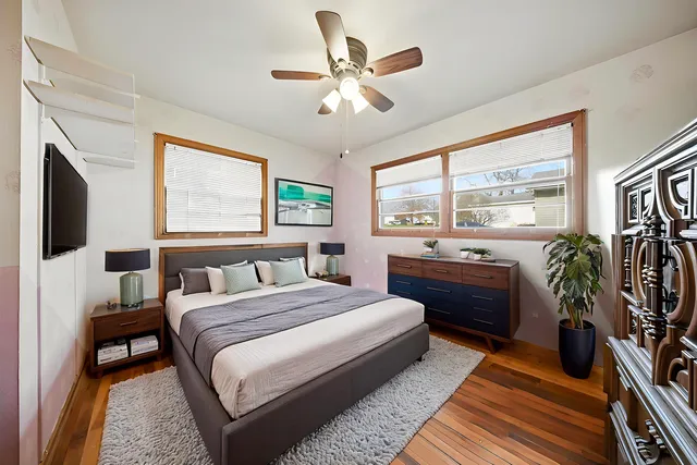 a bedroom with a large bed and a large window