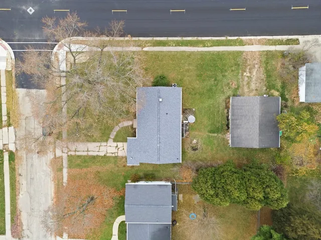 an aerial view of ocean with residential house and outdoor space
