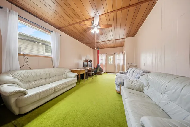 a living room with furniture and a dining table