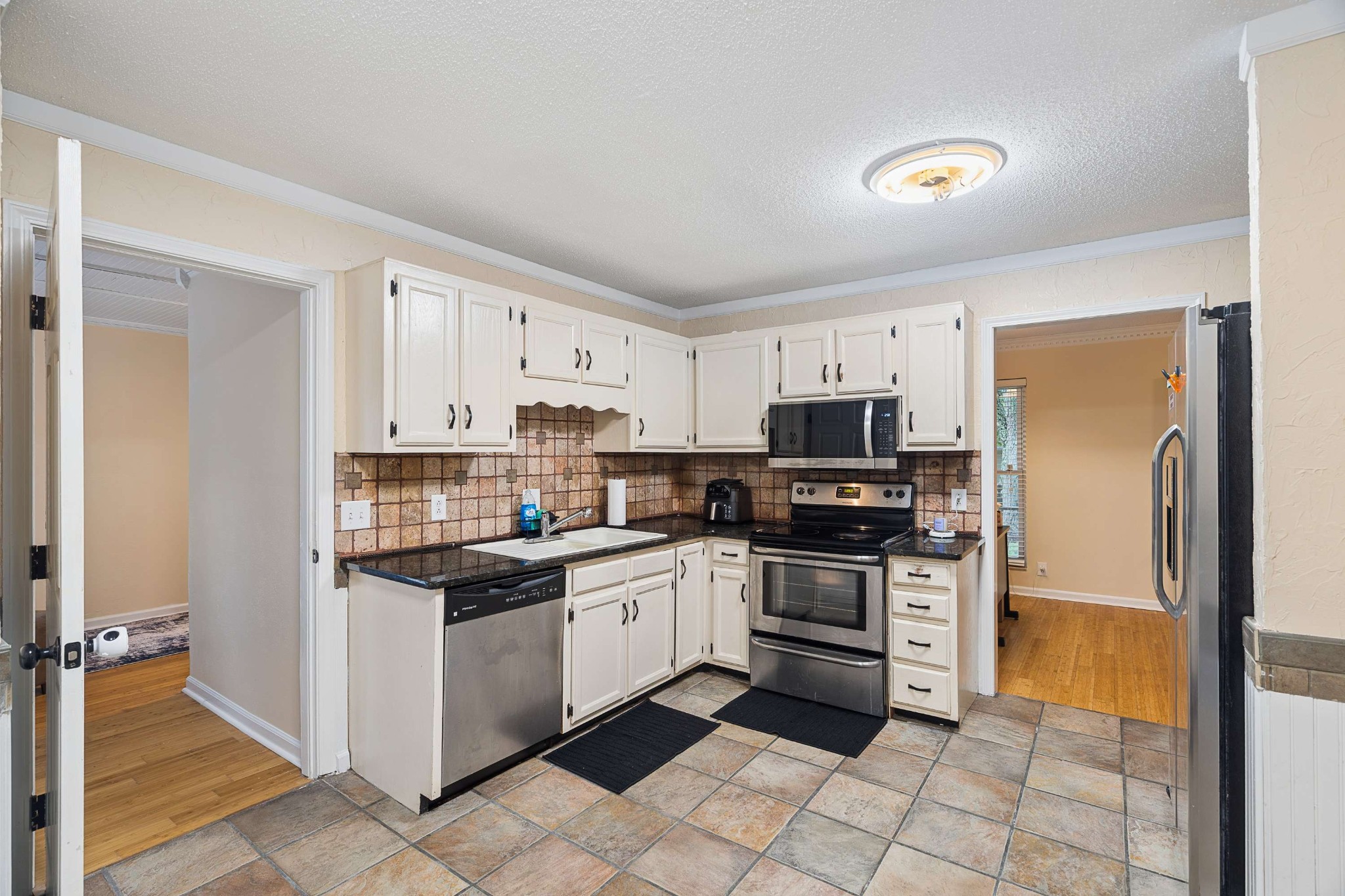 3332 Towne Village Road Antioch, TN 37013 - Photo 10 of 30 a kitchen with stainless steel appliances granite countertop a refrigerator and a stove top oven