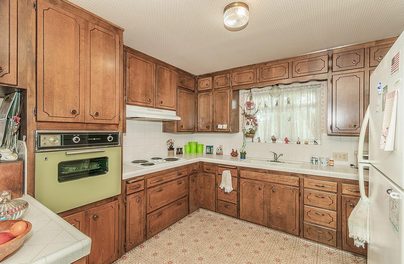 596 West Herbert Avenue Reedley, CA 93654 - Photo 11 of 30 a kitchen with a sink a stove and cabinets