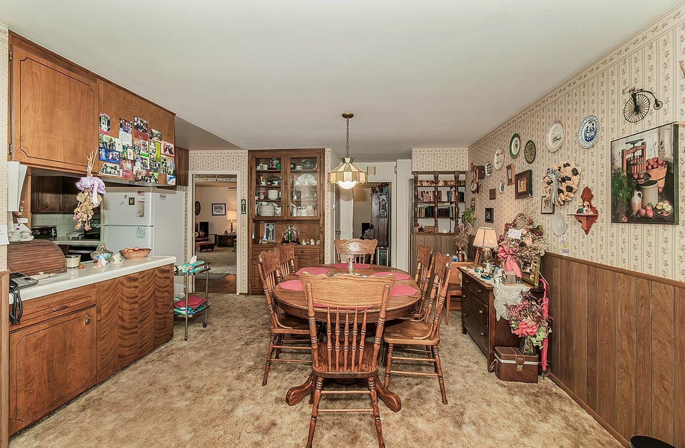 596 West Herbert Avenue Reedley, CA 93654 - Photo 12 of 30 a view of a dining room with furniture and chandelier