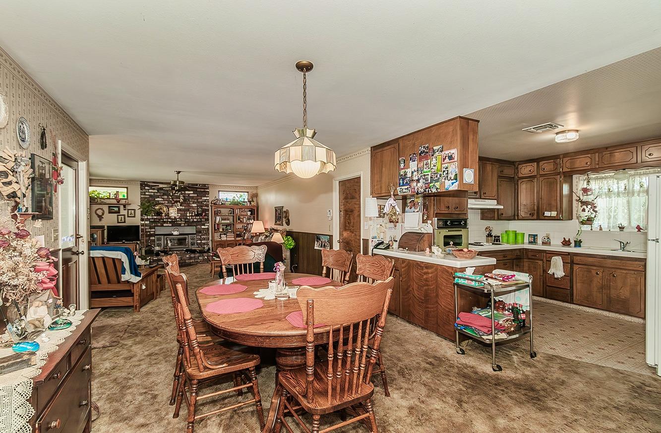 596 West Herbert Avenue Reedley, CA 93654 - Photo 13 of 30 a view of a dining room with furniture window and wooden floor