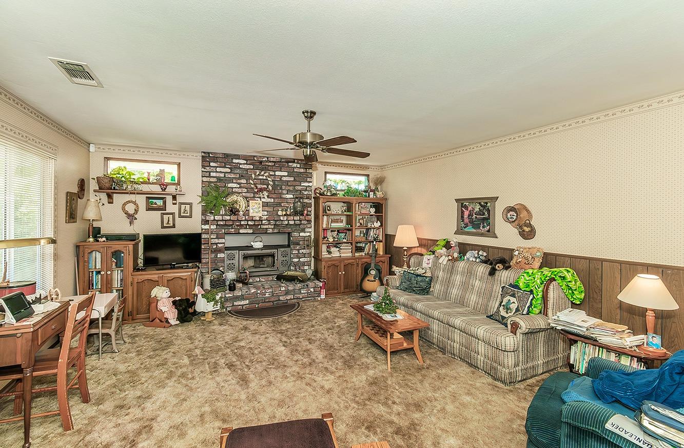 596 West Herbert Avenue Reedley, CA 93654 - Photo 16 of 30 a living room with furniture and a flat screen tv