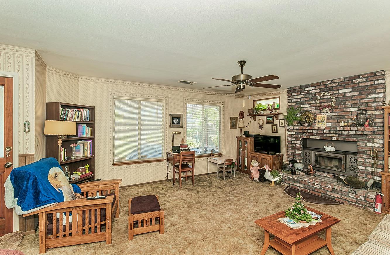 596 West Herbert Avenue Reedley, CA 93654 - Photo 17 of 30 a living room with furniture a rug and a fireplace