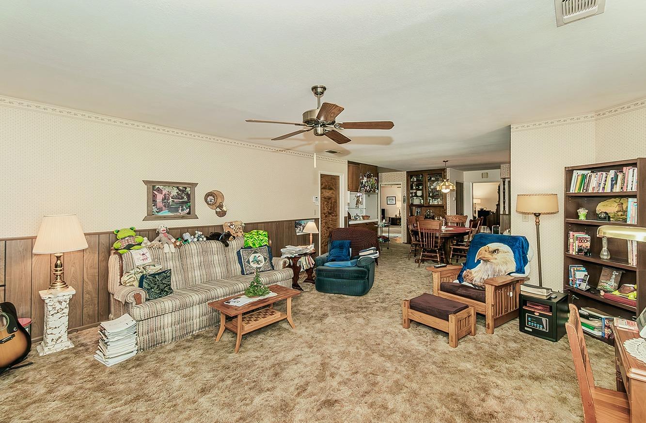 596 West Herbert Avenue Reedley, CA 93654 - Photo 18 of 30 a living room with furniture a rug and a chandelier