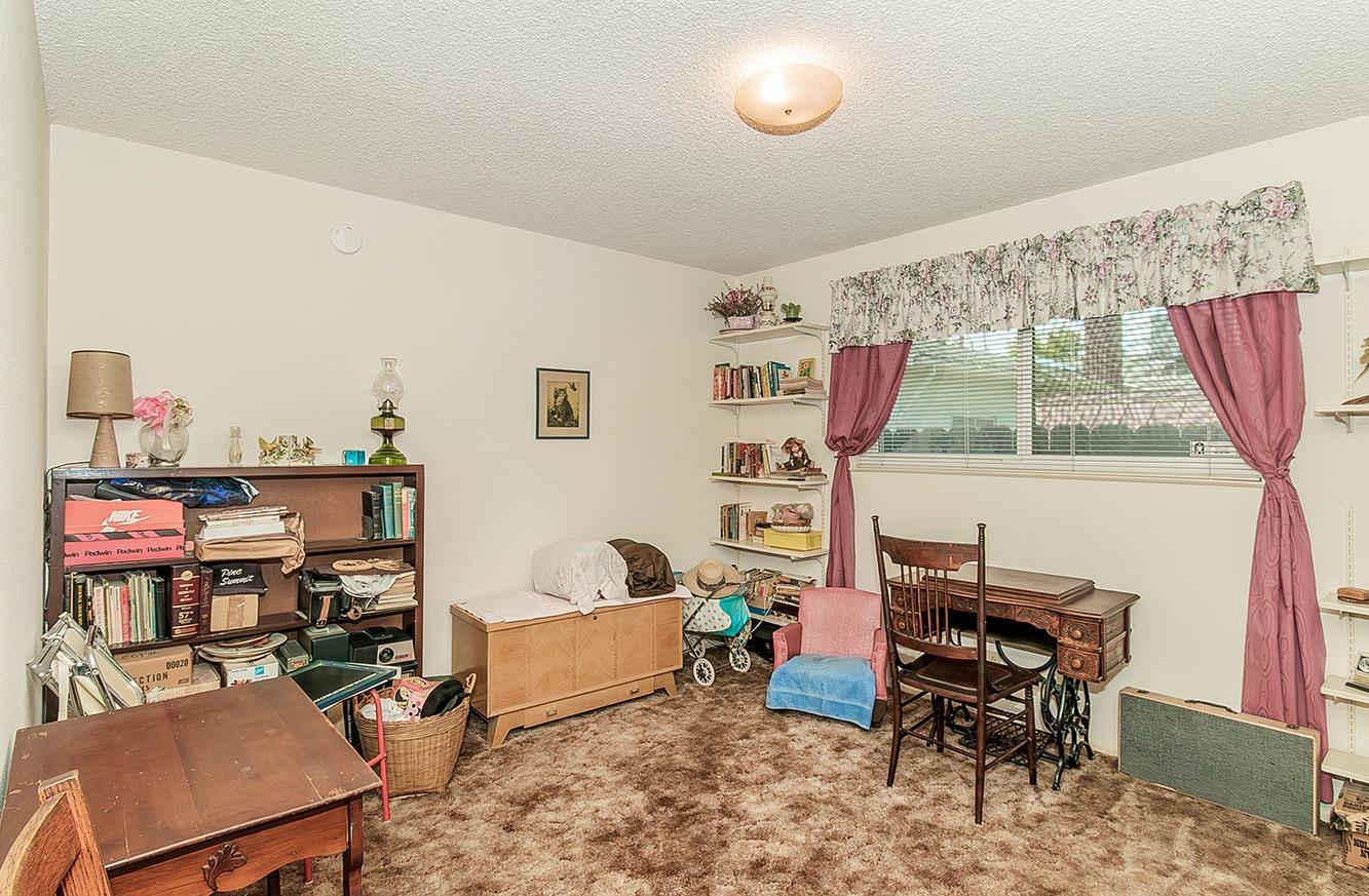 596 West Herbert Avenue Reedley, CA 93654 - Photo 24 of 30 a living room with furniture and a flat screen tv