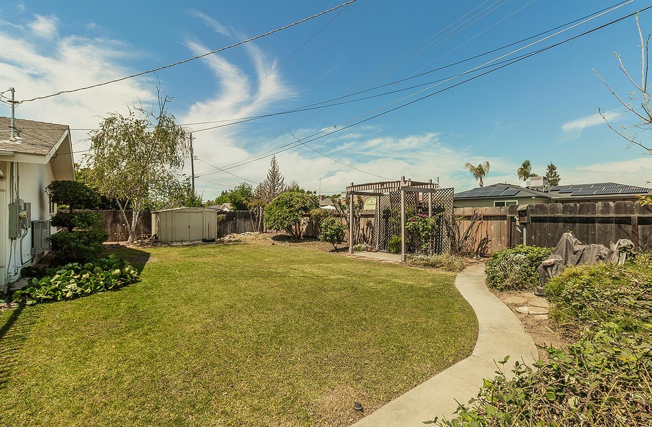 596 West Herbert Avenue Reedley, CA 93654 - Photo 28 of 30 a view of a swimming pool with a lawn chairs and potted plants