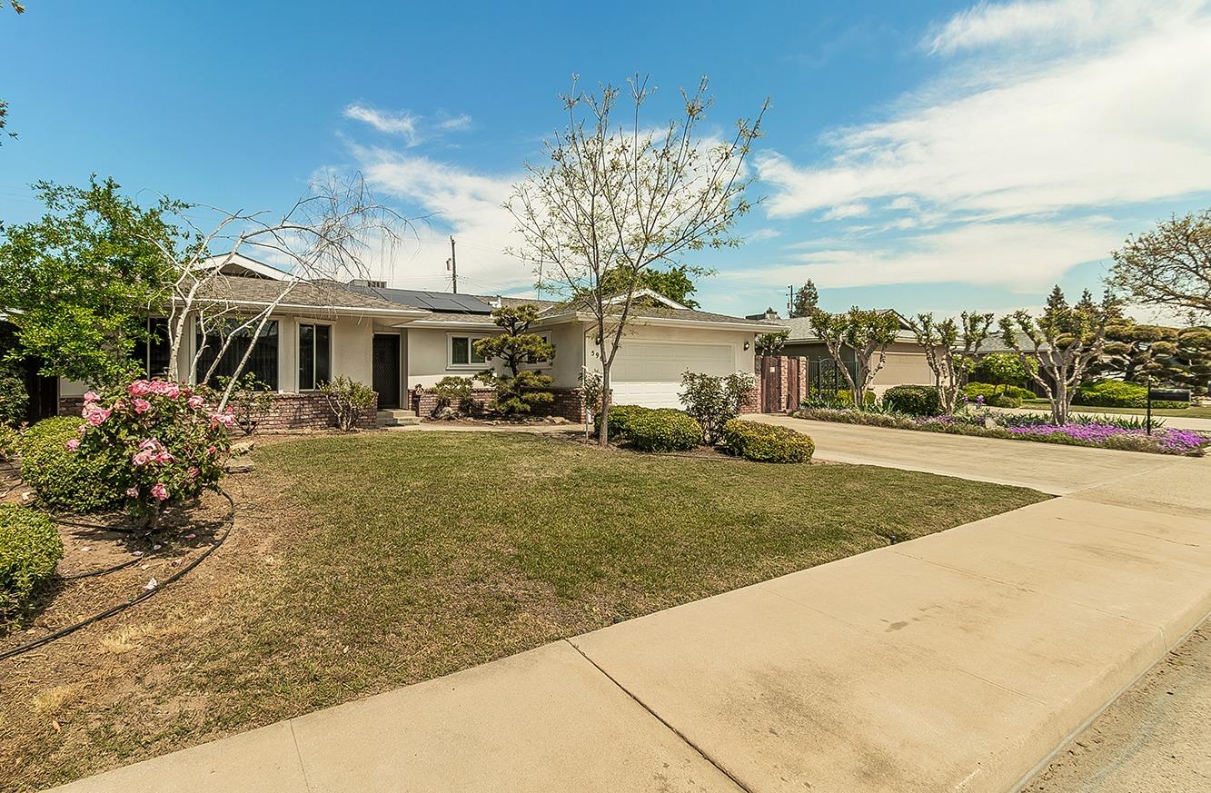 596 West Herbert Avenue Reedley, CA 93654 - Photo 3 of 30 a front view of a house with garden