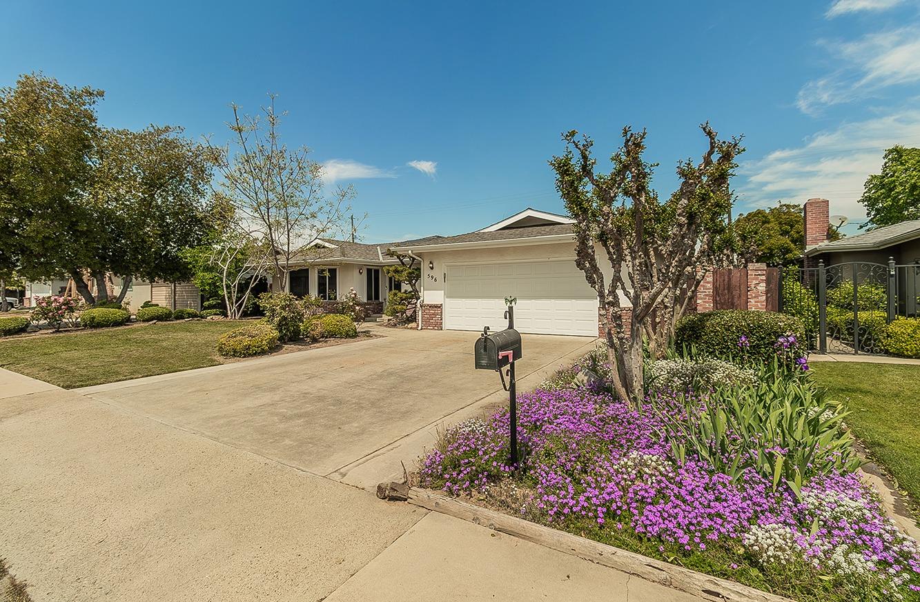 596 West Herbert Avenue Reedley, CA 93654 - Photo 4 of 30 a sign board with flower garden