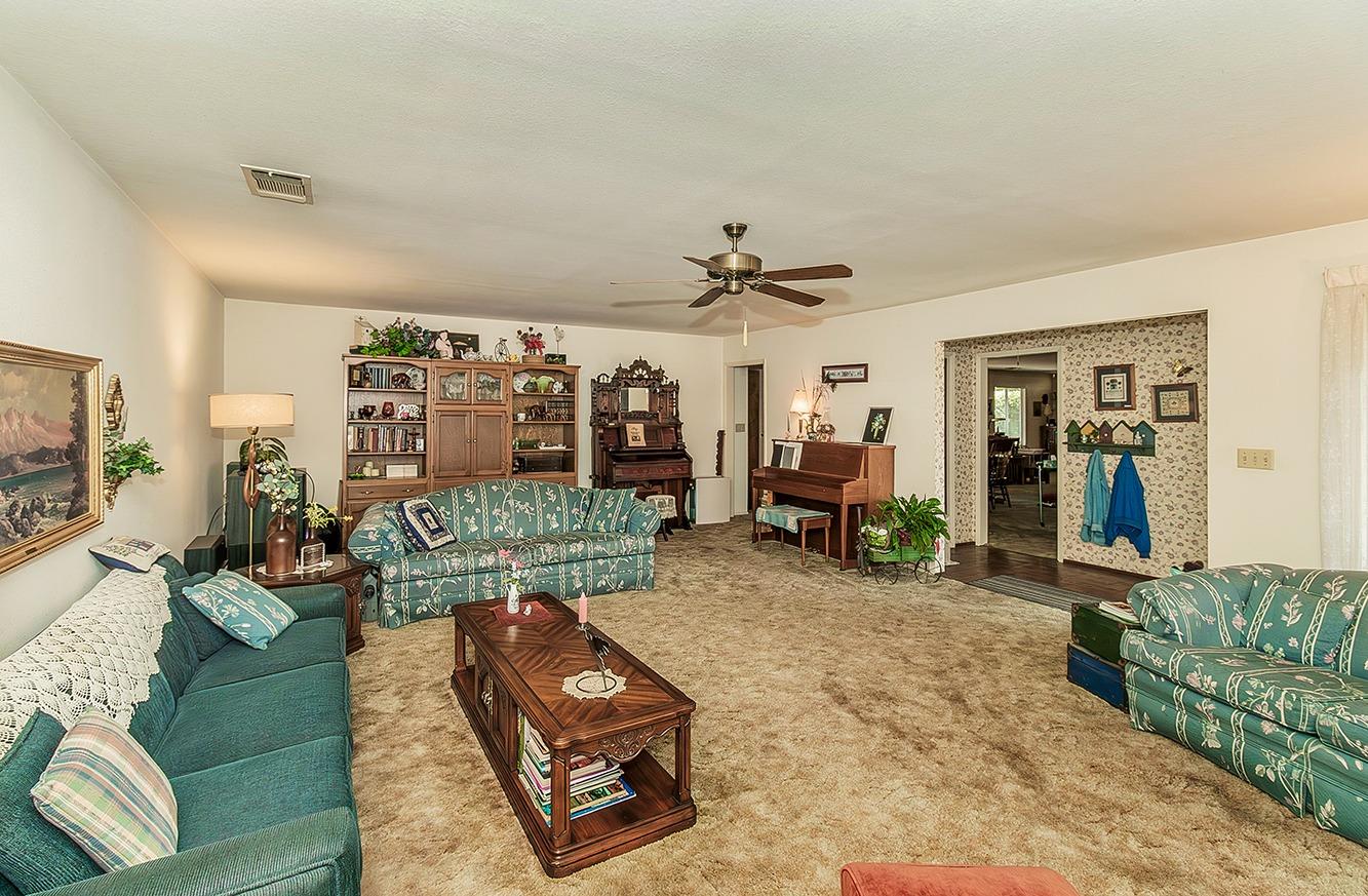 596 West Herbert Avenue Reedley, CA 93654 - Photo 6 of 30 a living room with furniture and a flat screen tv