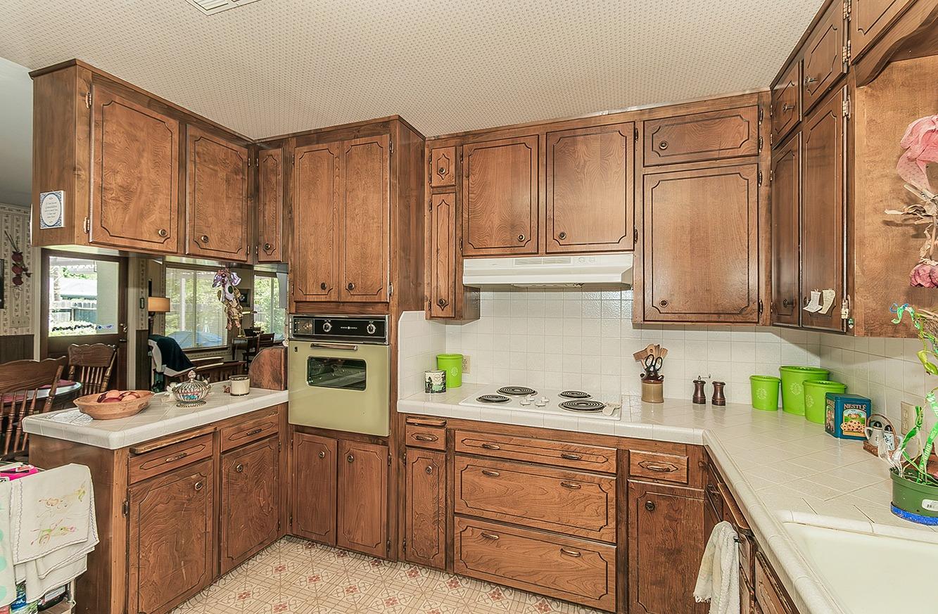 596 West Herbert Avenue Reedley, CA 93654 - Photo 9 of 30 a kitchen with a sink cabinets and appliances