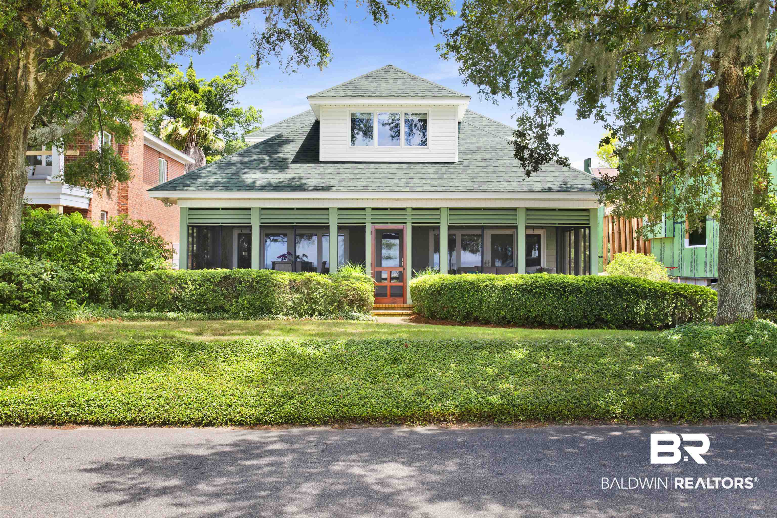 409 South Mobile Street Fairhope, AL 36532 - Photo 3 of 48 View of front of home featuring a shingled roof and a front lawn