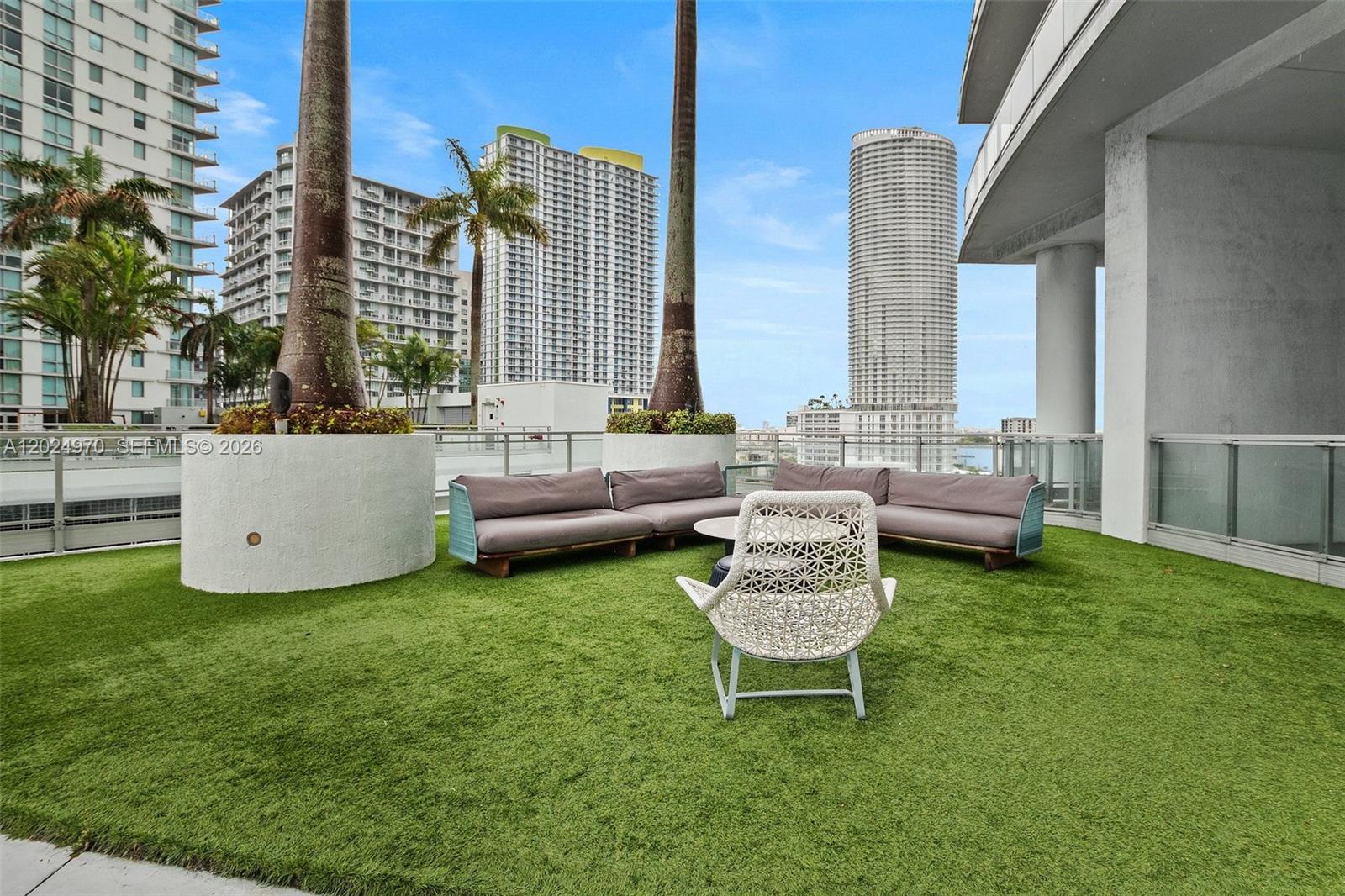 90 Southwest 3rd Street, Unit 3810 Miami, FL 33130 - Photo 34 of 45 a view of a patio with couches chairs and a fire pit