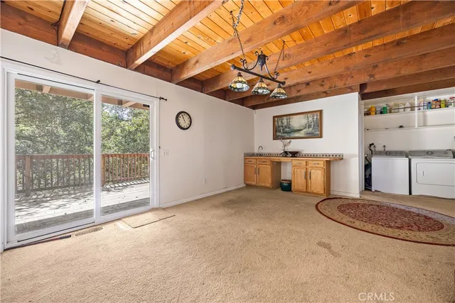 a view of a livingroom with furniture and a kitchen