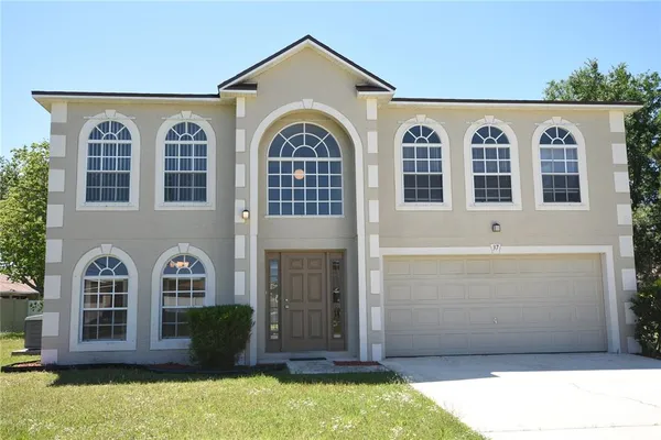 a front view of a house with large windows