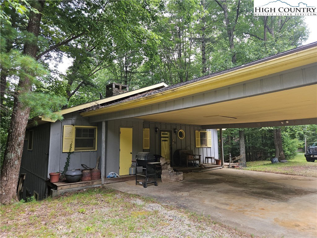 1783 Powder Horn Mountain Road Deep Gap, NC 28618 - Photo 3 of 7 a view of a patio with table and chairs and floor to ceiling window
