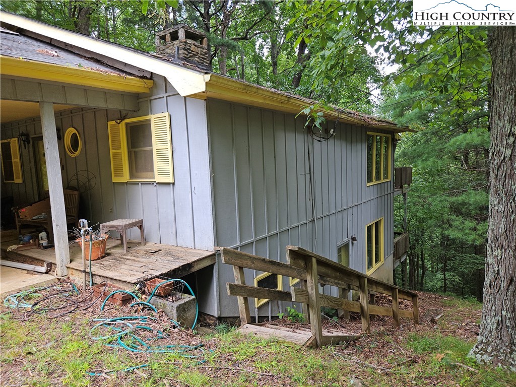 1783 Powder Horn Mountain Road Deep Gap, NC 28618 - Photo 4 of 7 a backyard of a house with table and chairs