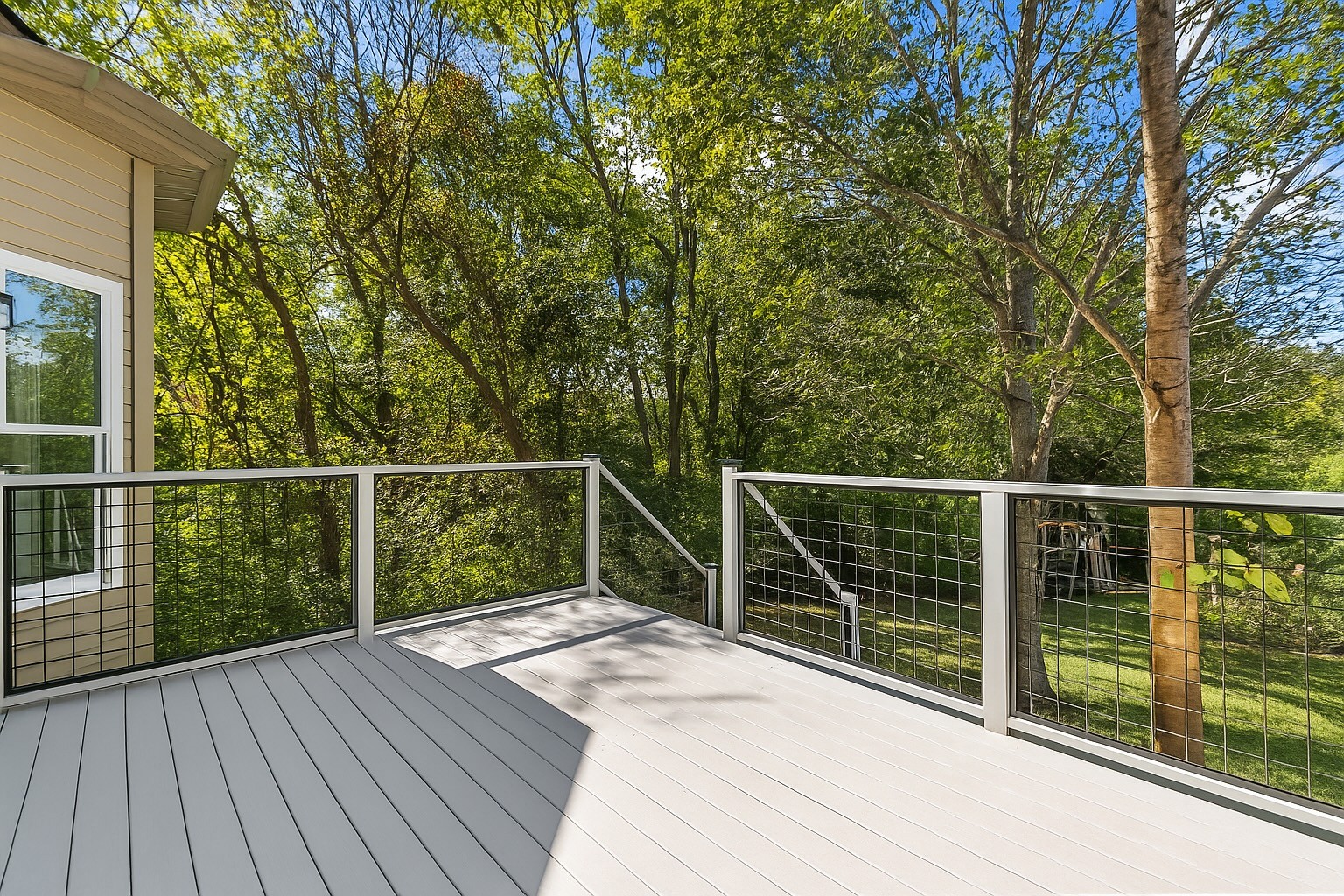 8013 Boone Trace Nashville, TN 37221 - Photo 27 of 34 a balcony with wooden floor next to a yard