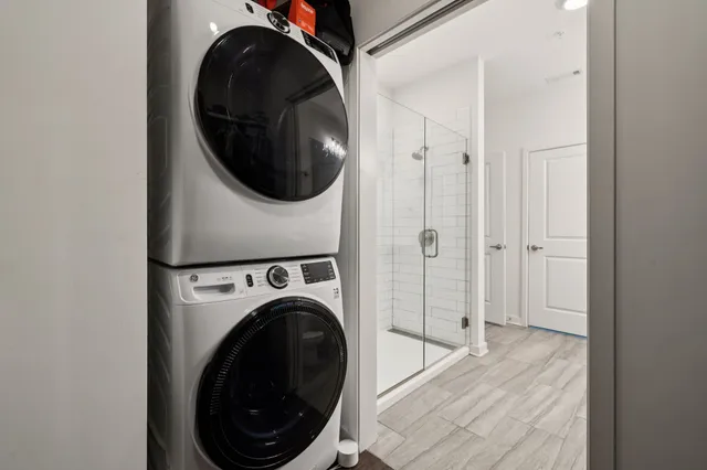 a view of a hallway with washer and dryer