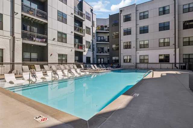 a swimming pool with outdoor seating and yard view