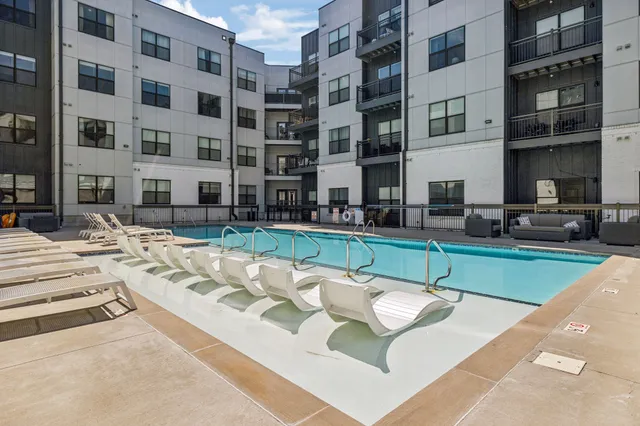 a view of a swimming pool with outdoor seating