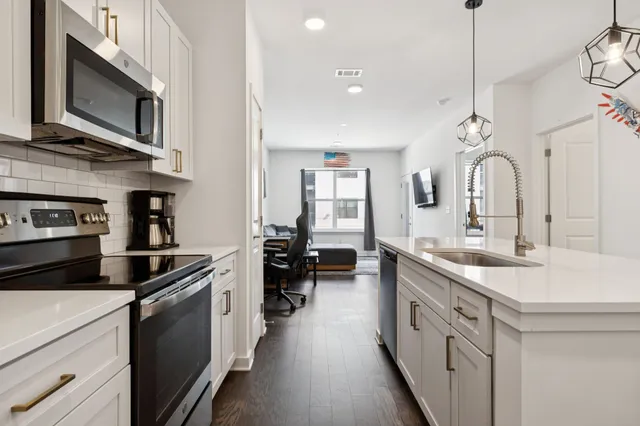 a kitchen with a sink stove and microwave