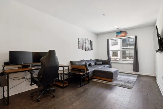 a view of a workspace with furniture and a window