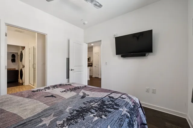 a bedroom with a bed and a flat screen tv