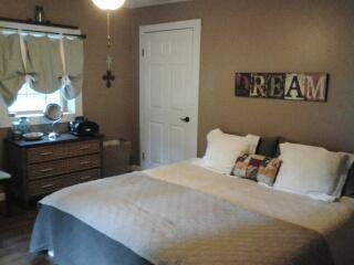 7282 Kingston Road Fairview, TN 37062 - Photo 12 of 20 a bedroom with a bed and a mirror on dresser
