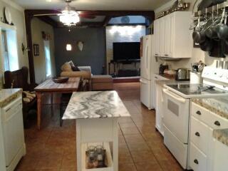 7282 Kingston Road Fairview, TN 37062 - Photo 10 of 20 a kitchen with stainless steel appliances granite countertop a stove a sink and a microwave