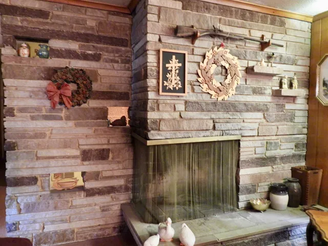 a living room with furniture and large windows